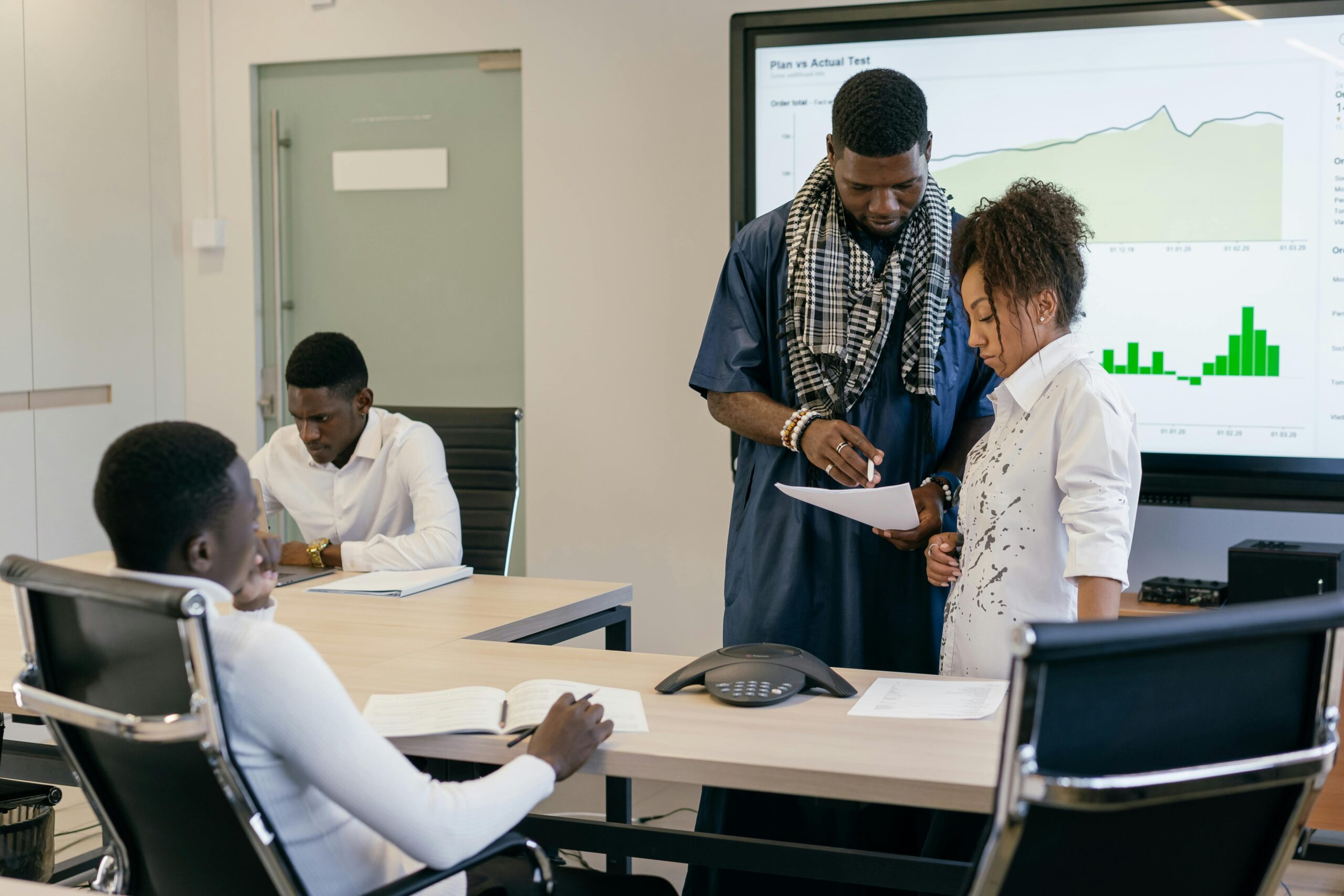 A diverse team of professionals collaborates on data analysis in a modern office setting.